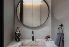 Bathroom Design With Circular Mirror And Neutral Tones