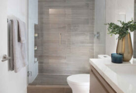 A Neutral Bathroom Design Featuring A Walk-in Shower With Wood-look Tiles.