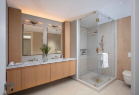 A Natural And Neutral Bathroom Design With A Double Vanity And Walk-in Shower.