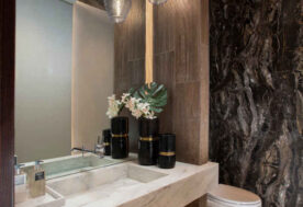 A Half Bathroom Design Featuring A Large Mirror That Creates An Illusion Of Depth And Amplitude.