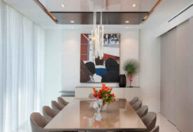 Dining Area Design Featuring Wall Art In A Modern Chateau Beach Residence.