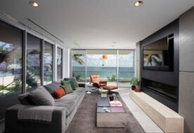 A Contemporary Oceanfront Retreat Home Showcasing A Living Room With An Ocean View.