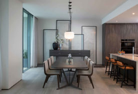 Modern Asian-inspired Penthouse Design Showcasing An Open Kitchen-dining Area Accented With Pendant Lighting And Complemented By Framed Fabric Wall Art.