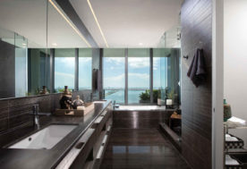 Modern Asian-inspired Penthouse Design Featuring A Master Bathroom Complemented By A Cityscape View With Waterfront Vistas.