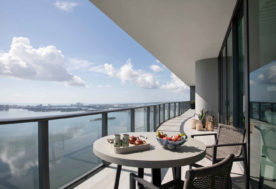 Modern Asian-inspired Penthouse Design Showcasing A Balcony With Waterfront Vistas By DKOR Interiors.