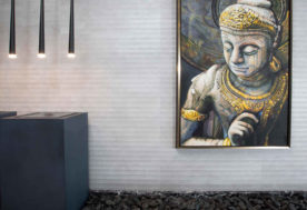 Modern-Asian Inspired Penthouse Design Showcases A Foyer Adorned With An Indoor Water Fountain, Pendant Lighting, And Wall Art.