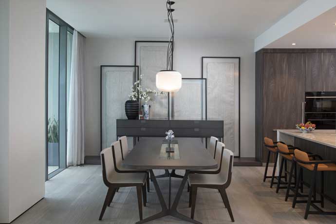 The 'after' state of an open-concept kitchen and dining area design in a modern Asian penthouse.
