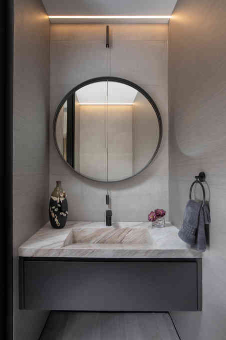 The 'after' state of a powder room design in a modern Asian penthouse.