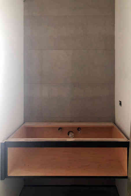 The 'before' state of a powder room design in a modern Asian penthouse.