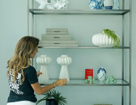 Shelf Decor Essentials Design Tips Featuring An Interior Designer Styling A Shelf.