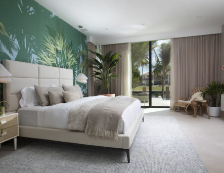 A Tropical Resort-inspired Guest Room With Tropical Wallcovering And Potted Tropical Plants.