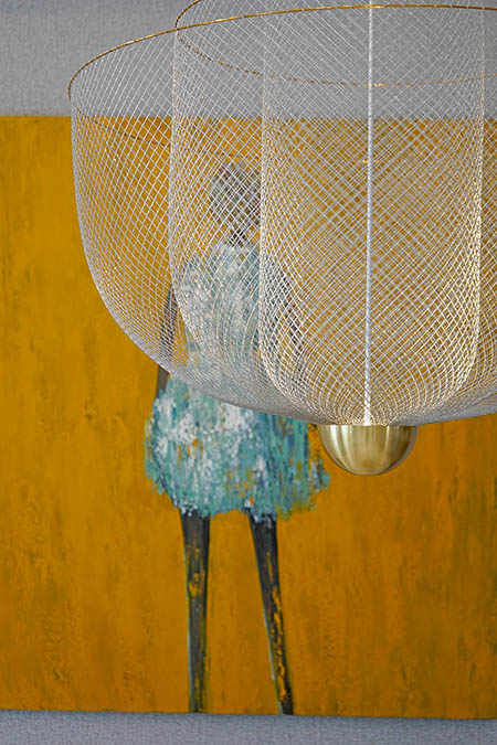 yellow art and chandelier