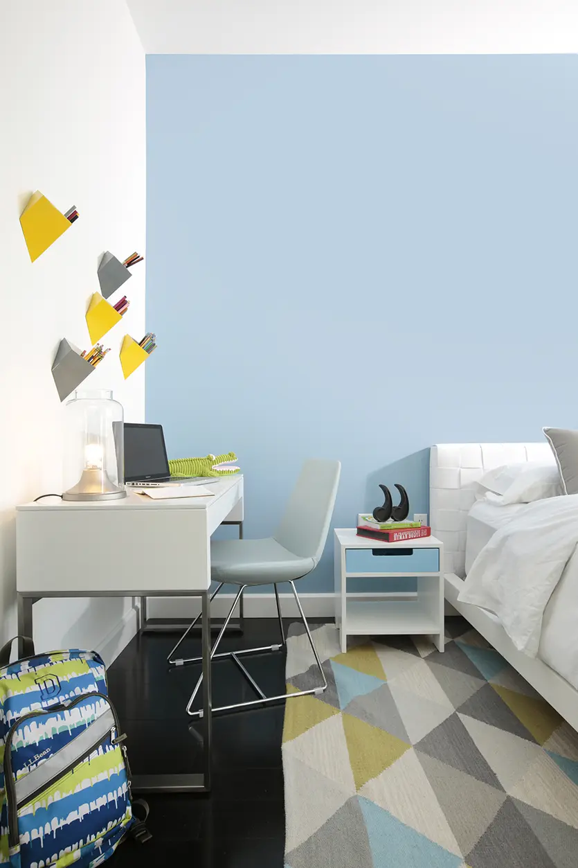 A sky-blue boys' bedroom design with a desk area