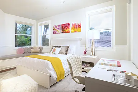 Kids bedroom designs gallery: A girl's bedroom with a neutral design, featuring yellow and pink touches in the accessories