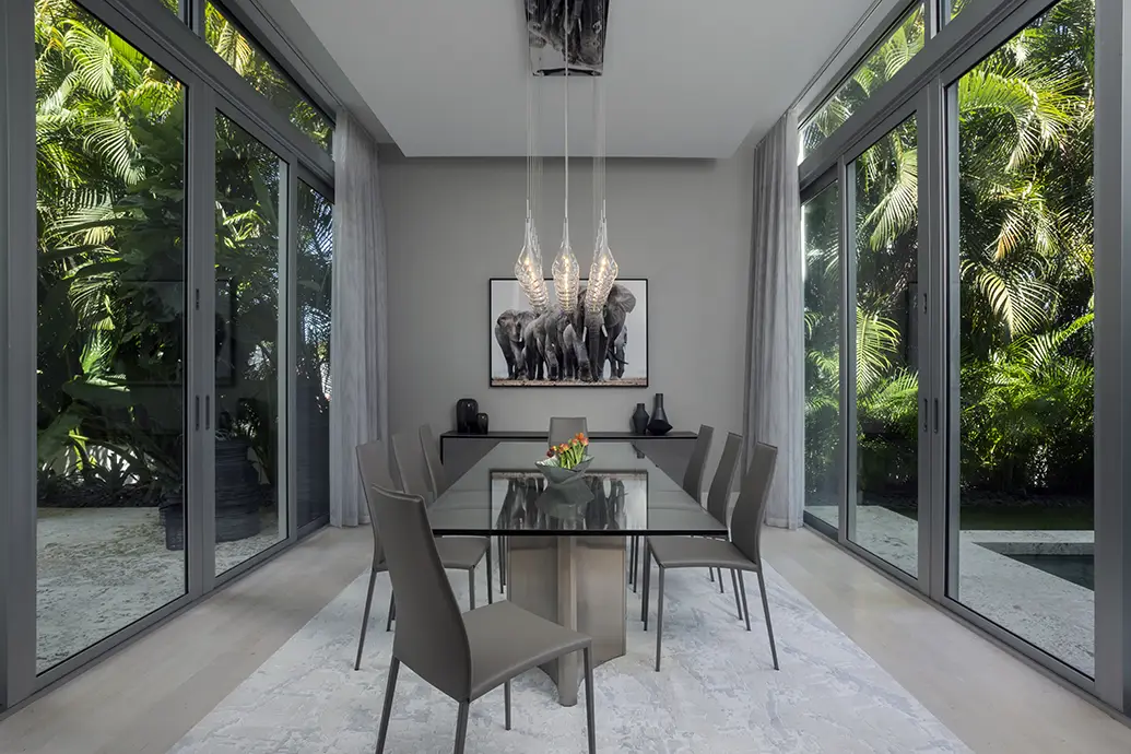 Dining room designs by Miami design firm with glass tables