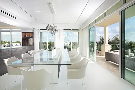 White dining room design with glass table