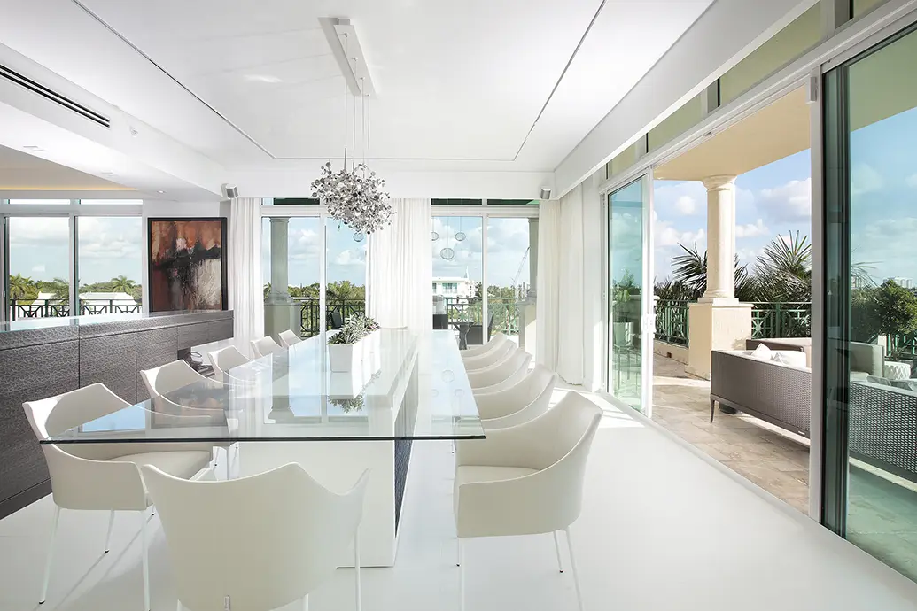 White dining room design with glass table